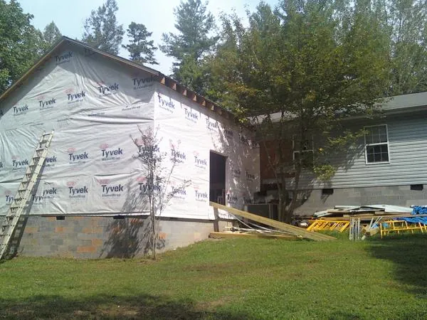 Tyvek wrapped gable on a new room addition beside an existing home in Rowe